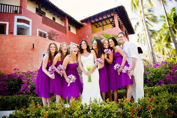 photo by Denver based wedding photographer Jared Wilson - bride laughing with her bridesmaids - purple bridesmaids dresses